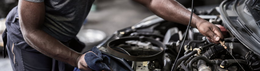 Mechanic working on car engine